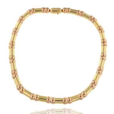 Bicolor gold flexible necklace with spherical and rod-shaped links