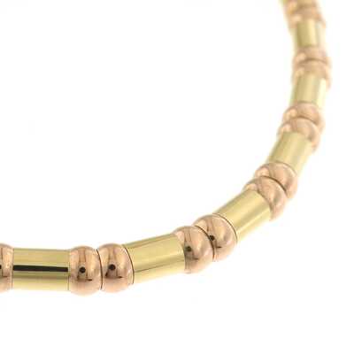 Bicolor gold flexible necklace with spherical and rod-shaped links