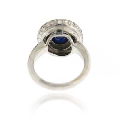White gold ring with oval sapphire cabochon and diamonds